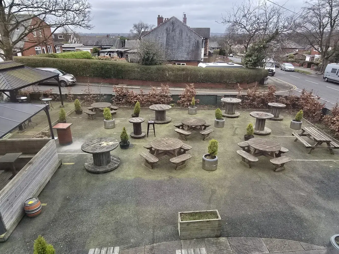 Pub beer garden with green algae-stained surface before commercial jet washing