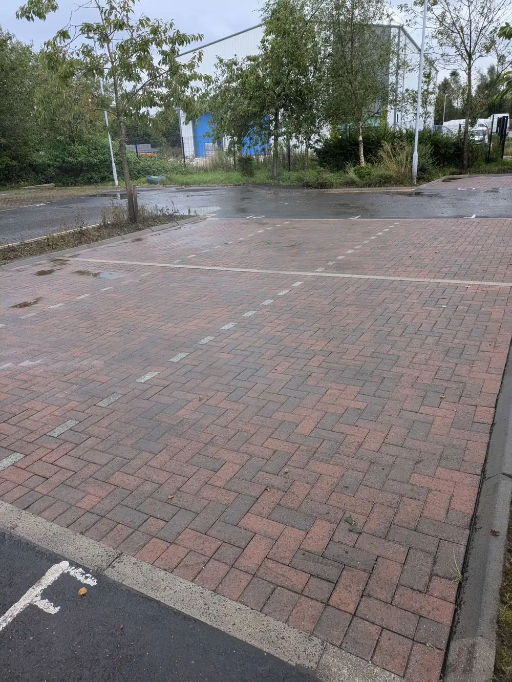 The same commercial car park after pressure washing