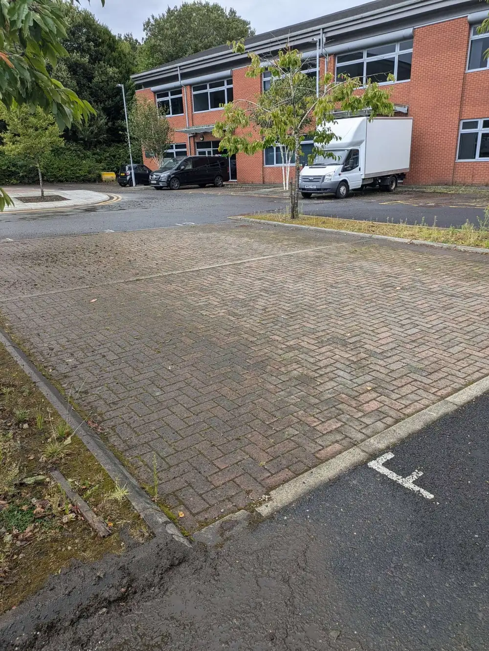 Commercial car park stained and dirty before pressure washing