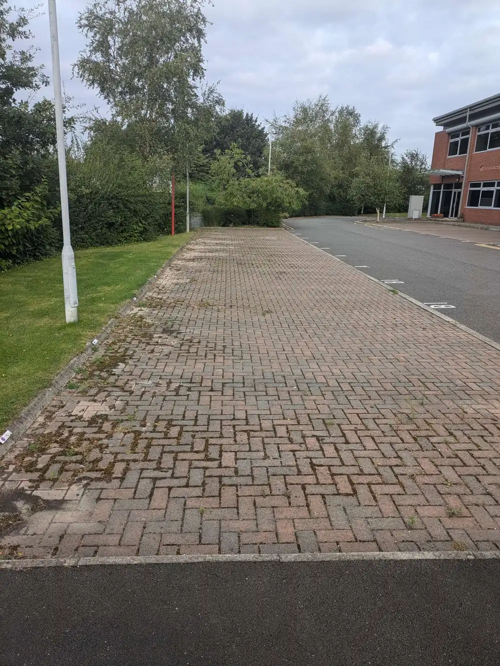 Business forecourt covered in grime before pressure washing