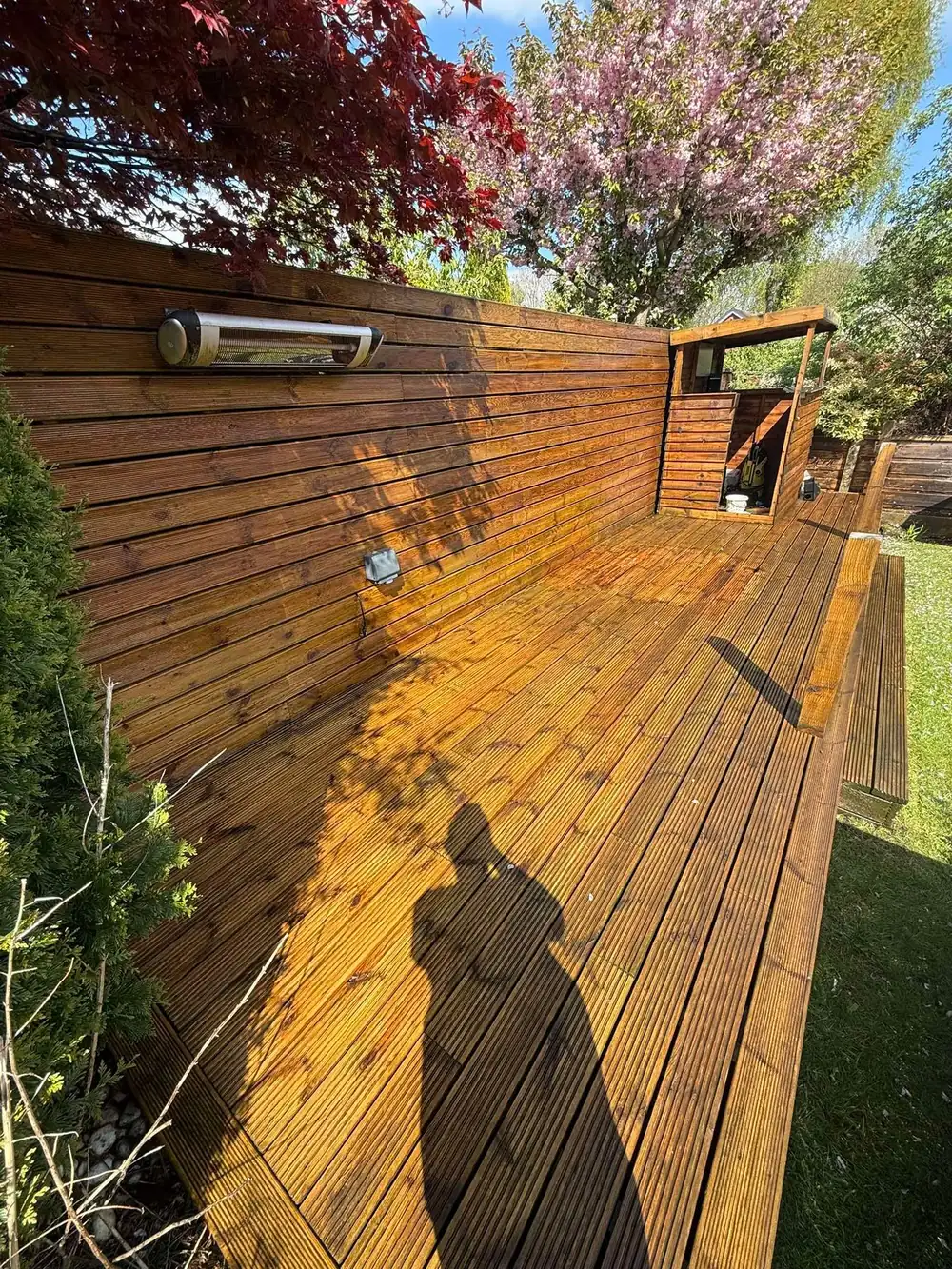The same decking after cleaning, golden timber revealed