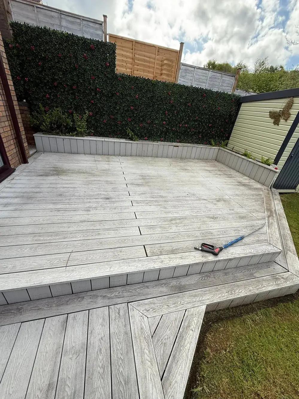 Dirty grey composite decking before cleaning