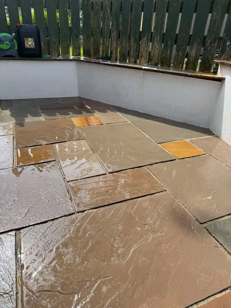 The same sandstone patio after pressure washing by Elite Jetwashing Services, golden stone restored